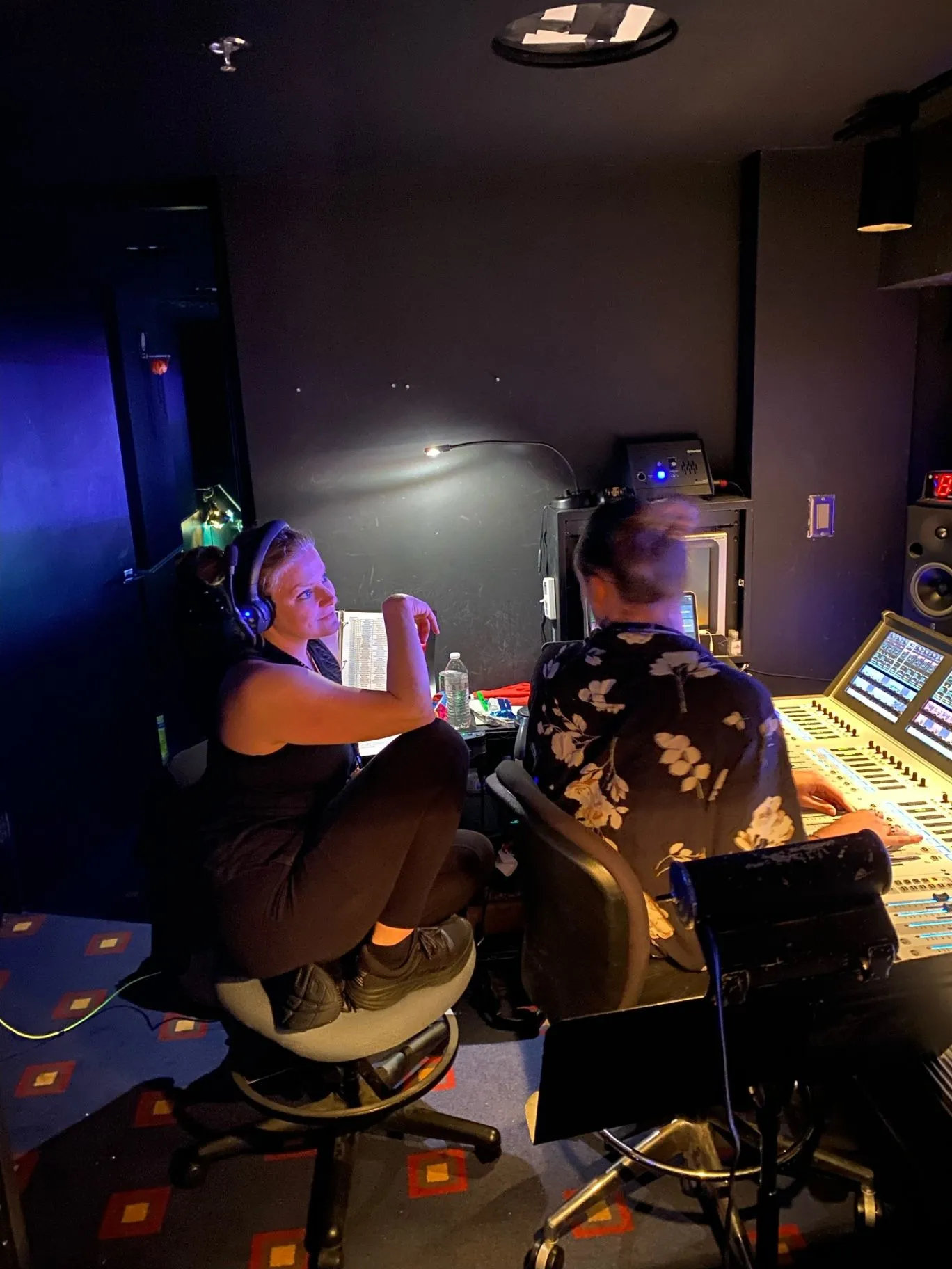 Susan watching the show from a control room desk