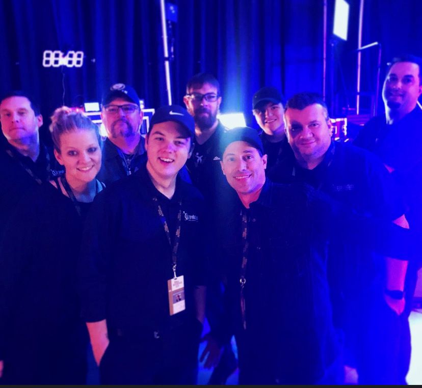 Full production crew in blue stage light