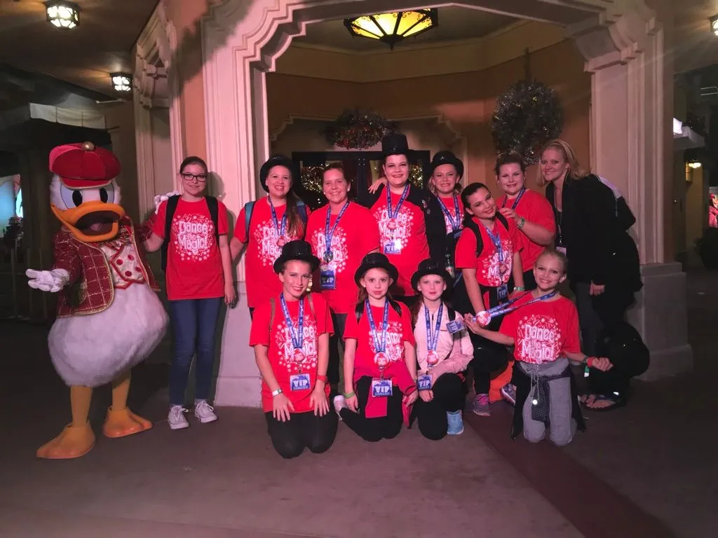 Susan with a group of young dancers wearing Dance the Magic shirts