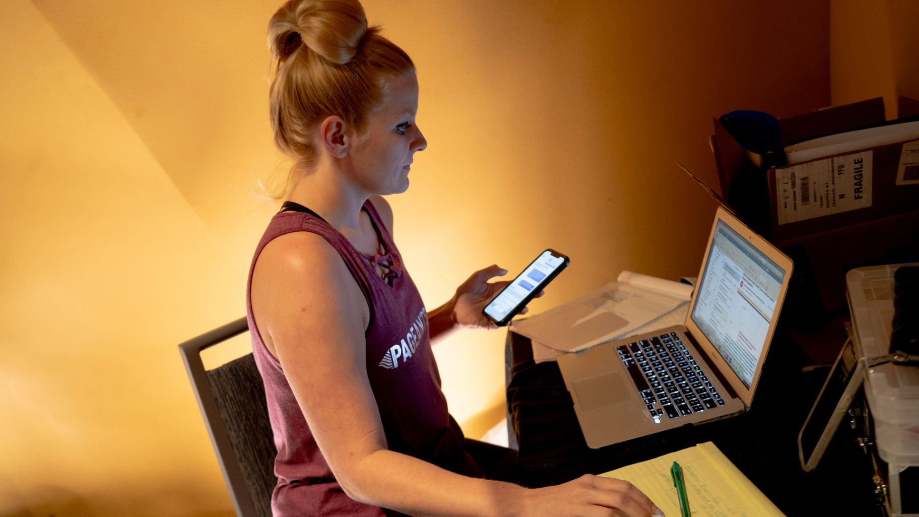 Susan working at a laptop and phone backstage
