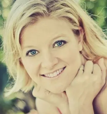 Susan Ables smiling in a sunlit natural-light portrait